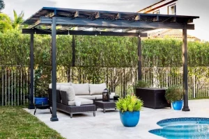 A freestanding pergola over a concrete pool deck.